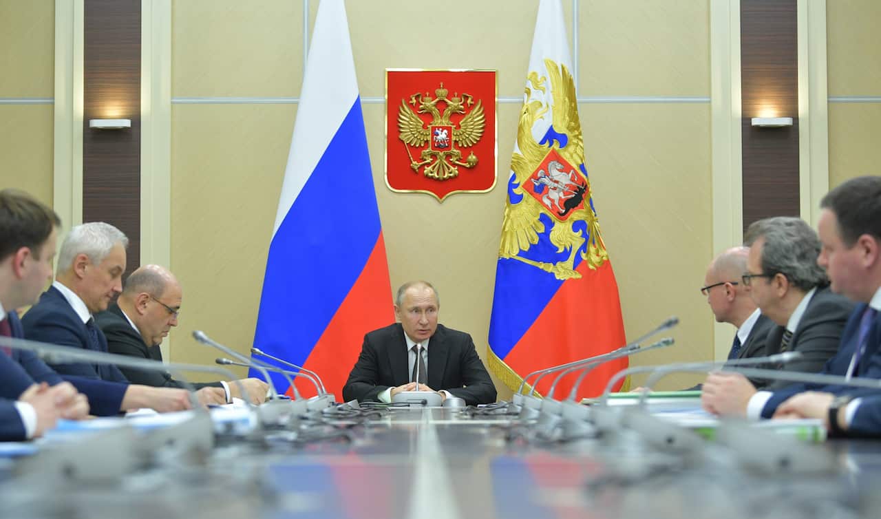 Russian President Vladimir Putin (C) chairs a meeting on measures to support the Russian economy taking into account the spread of coronavirus.