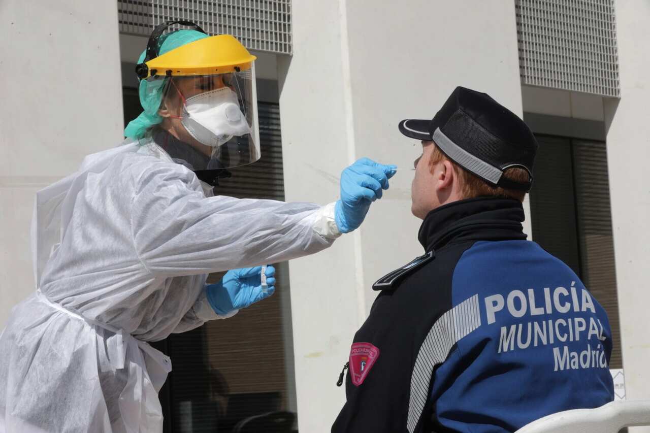 A medical biologist of Madrid Salud handles a swab to test a Madrid's regional police at Casa de Campo in Madrid, Spain
