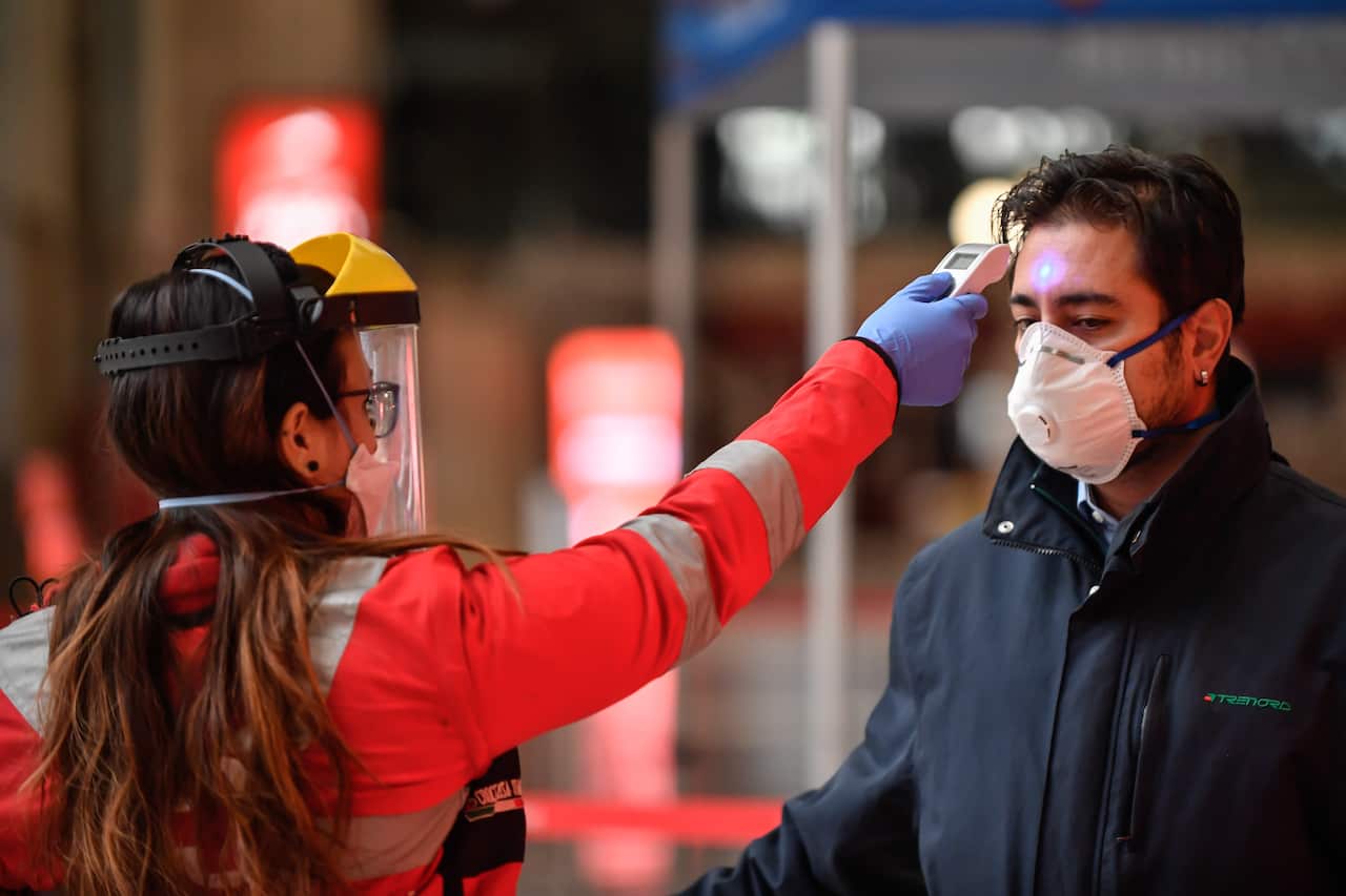 25 March 2020 Milano (Italy).Military and railway police checks at the access gates for departures in a deserted central station.In the photo: the detection of body temperature by health personnel (Photo by Claudio Furlan/LaPresse/Sipa USA)