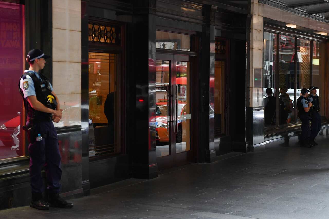NSW Police stand guard outside the Swissotel Hotel in Market Street, Sydney.
