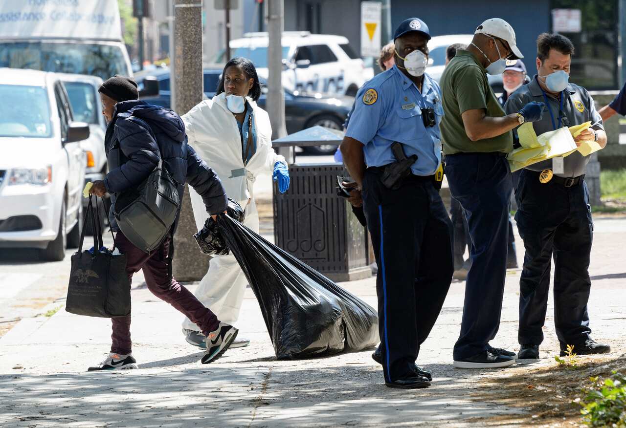 A person drags their belonging after registering for temporary housing due to the coronavirus outbreak in New Orleans, , 26 March, 2020. 