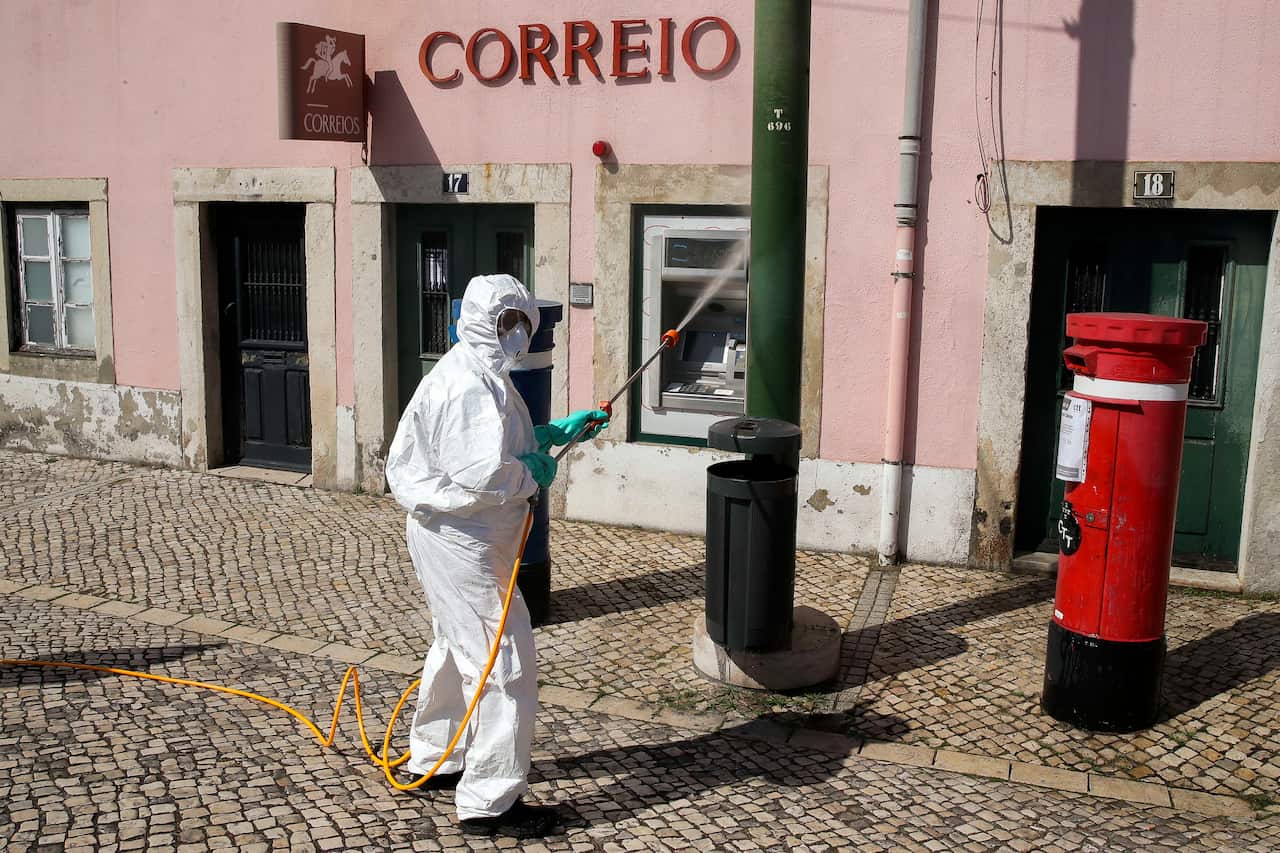 A municipal worker during the desinfection of the streets close to Belem Palace in Lisbon.