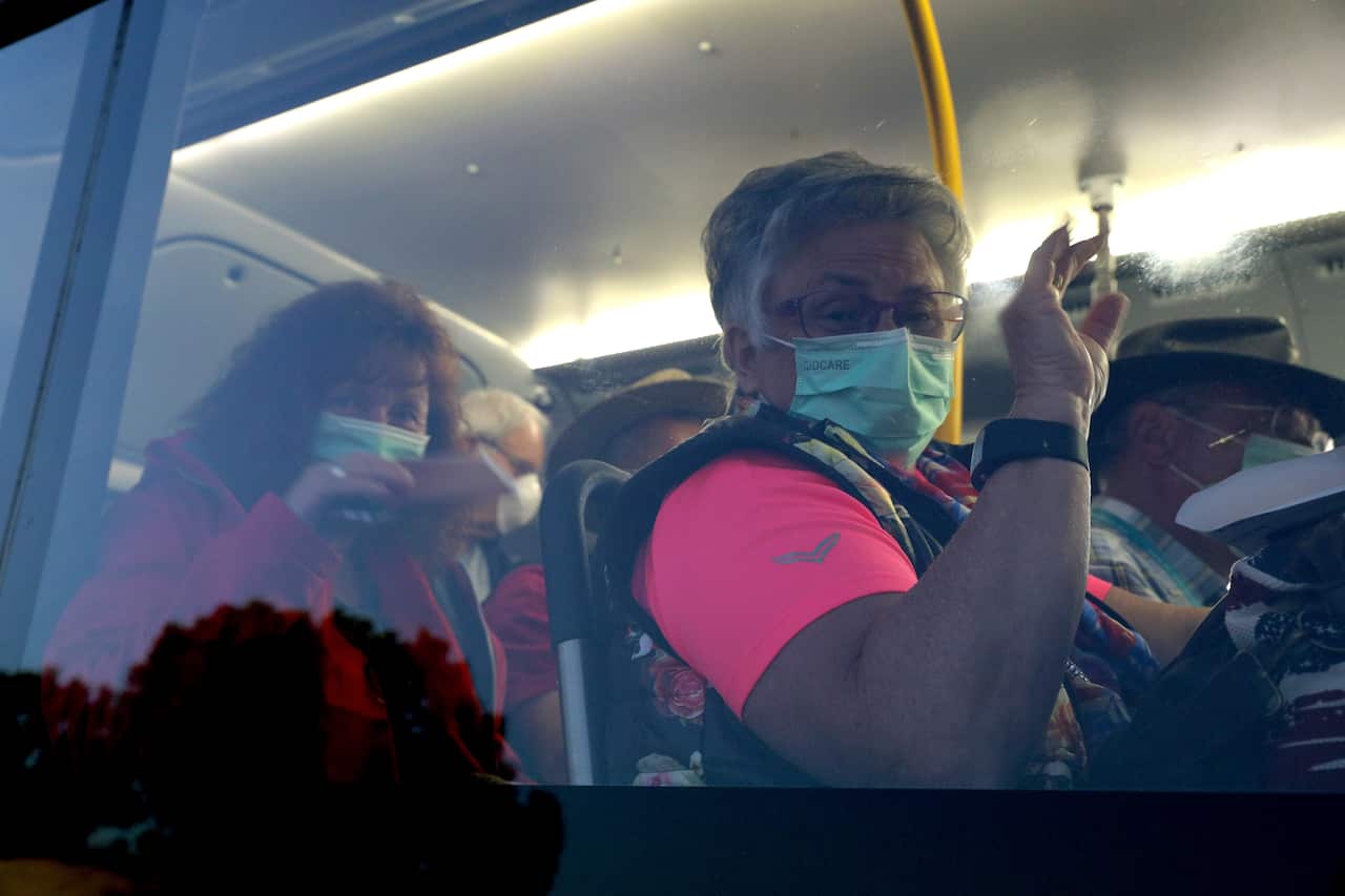 Passengers from the cruise ship MS Artania are seen arriving at Perth airport on buses before boarding a charter flight back to Germany, 29 March, 2020. 