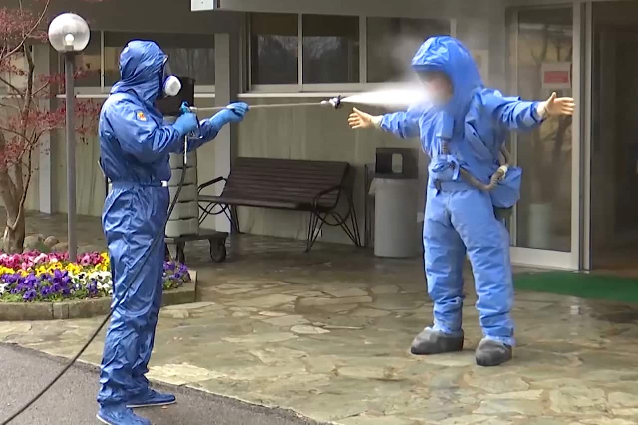 Military specialists in protective suits after disinfection work at a care facility for the elderly in Lombardy, northern Italy.