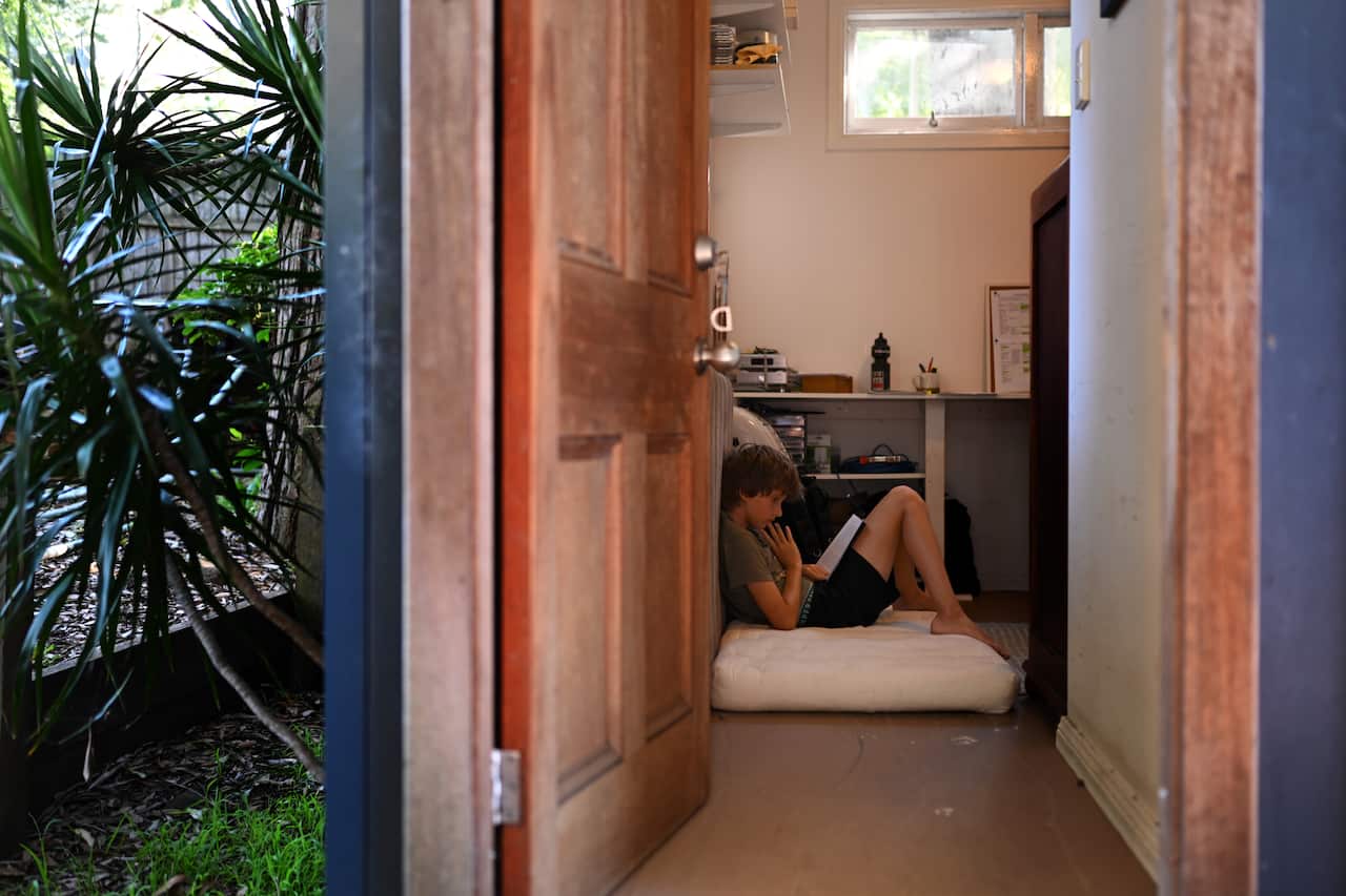 A Sydney primary school student finds a quiet spot to read during the COVID-19 pandemic. 