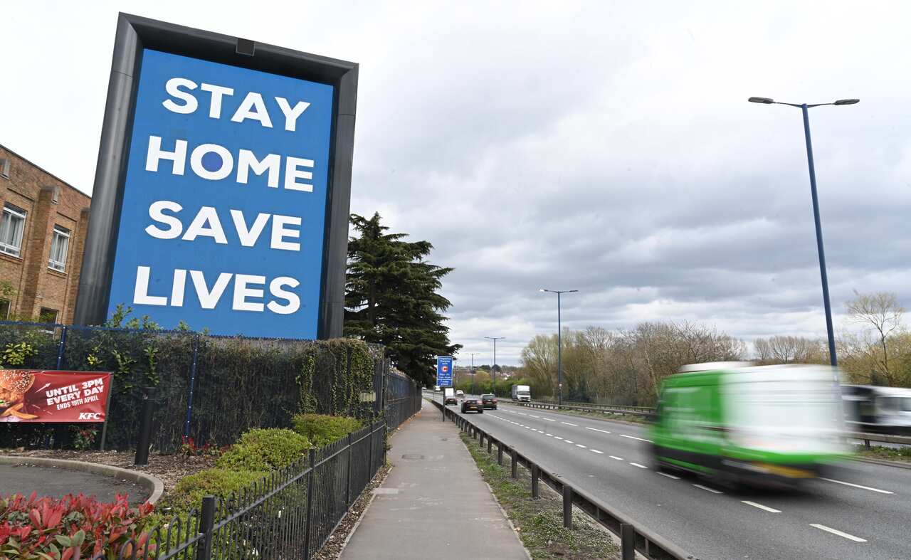 A public service sign reading 'Stay Home, Save Lives' is displayed on a road in London, Britain, 02 April 2020.