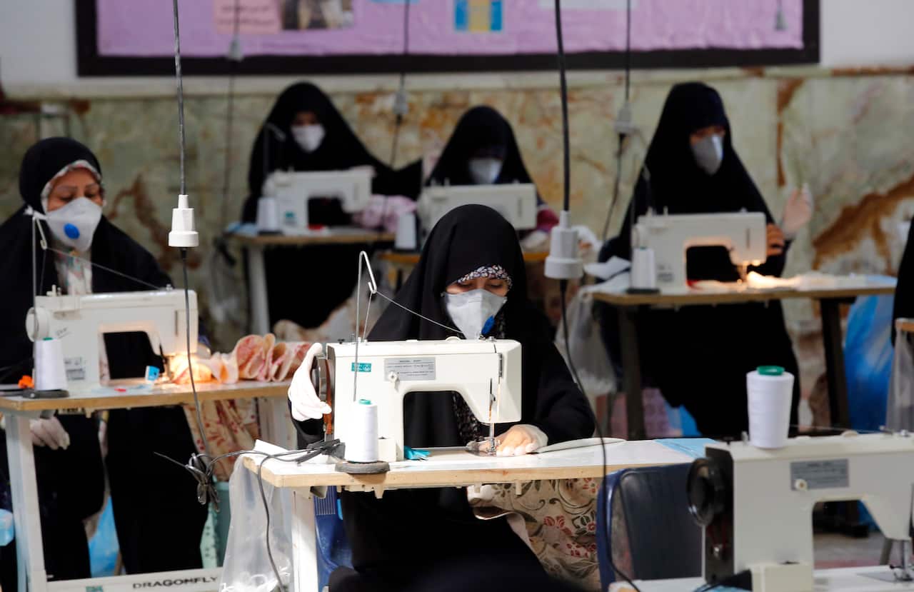 Women make face masks and other protective items at a mosque in the Qasem shrine in Tehran, Iran.
