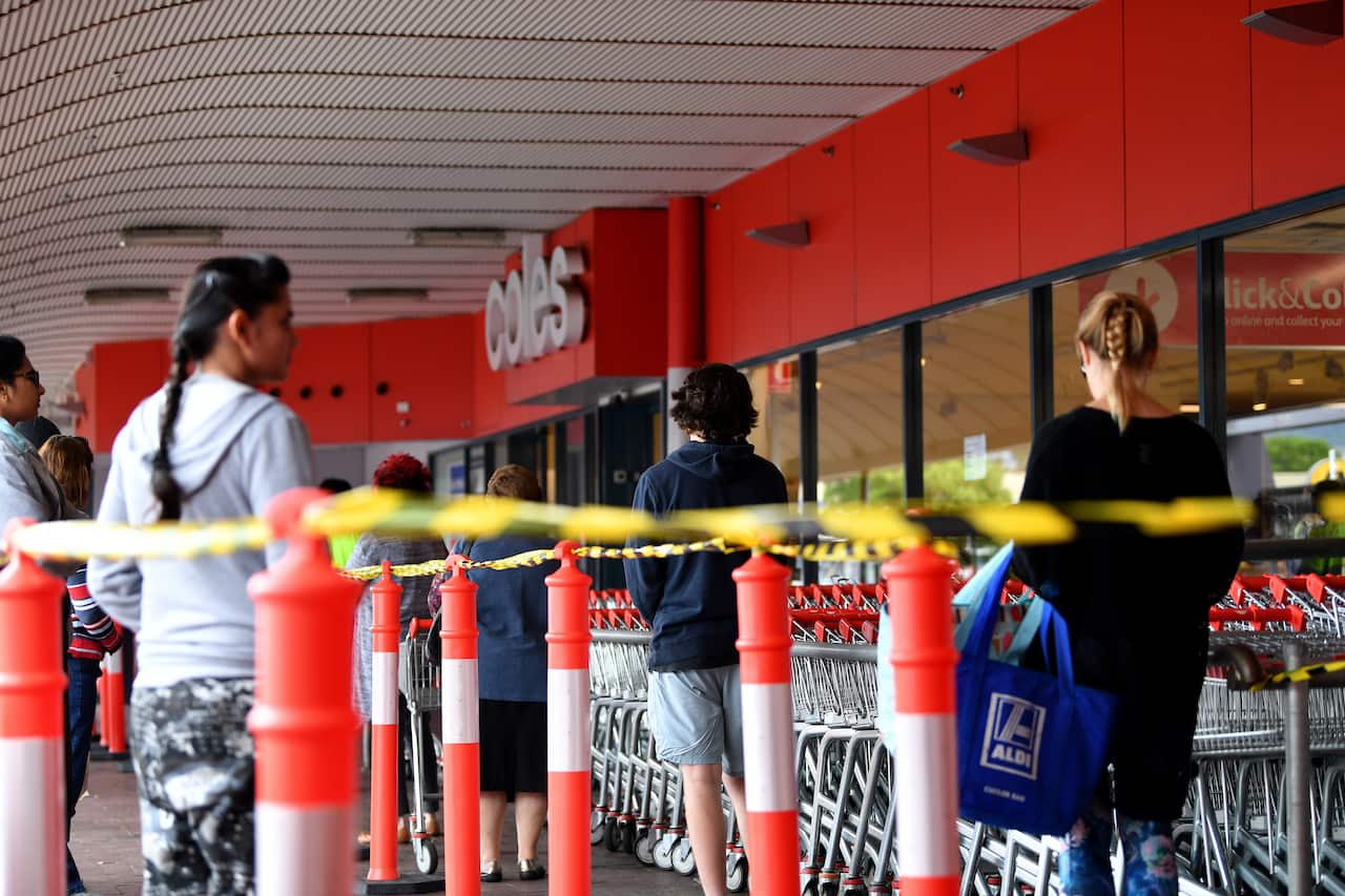 Shoppers waiting outside a Coles supermarket at Firle in Adelaide.