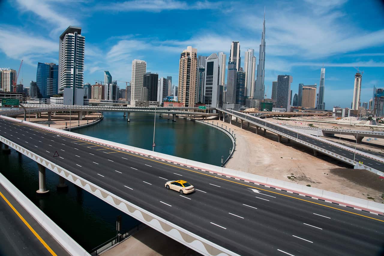 A lone taxi drives over a typically gridlocked highway in Dubai.