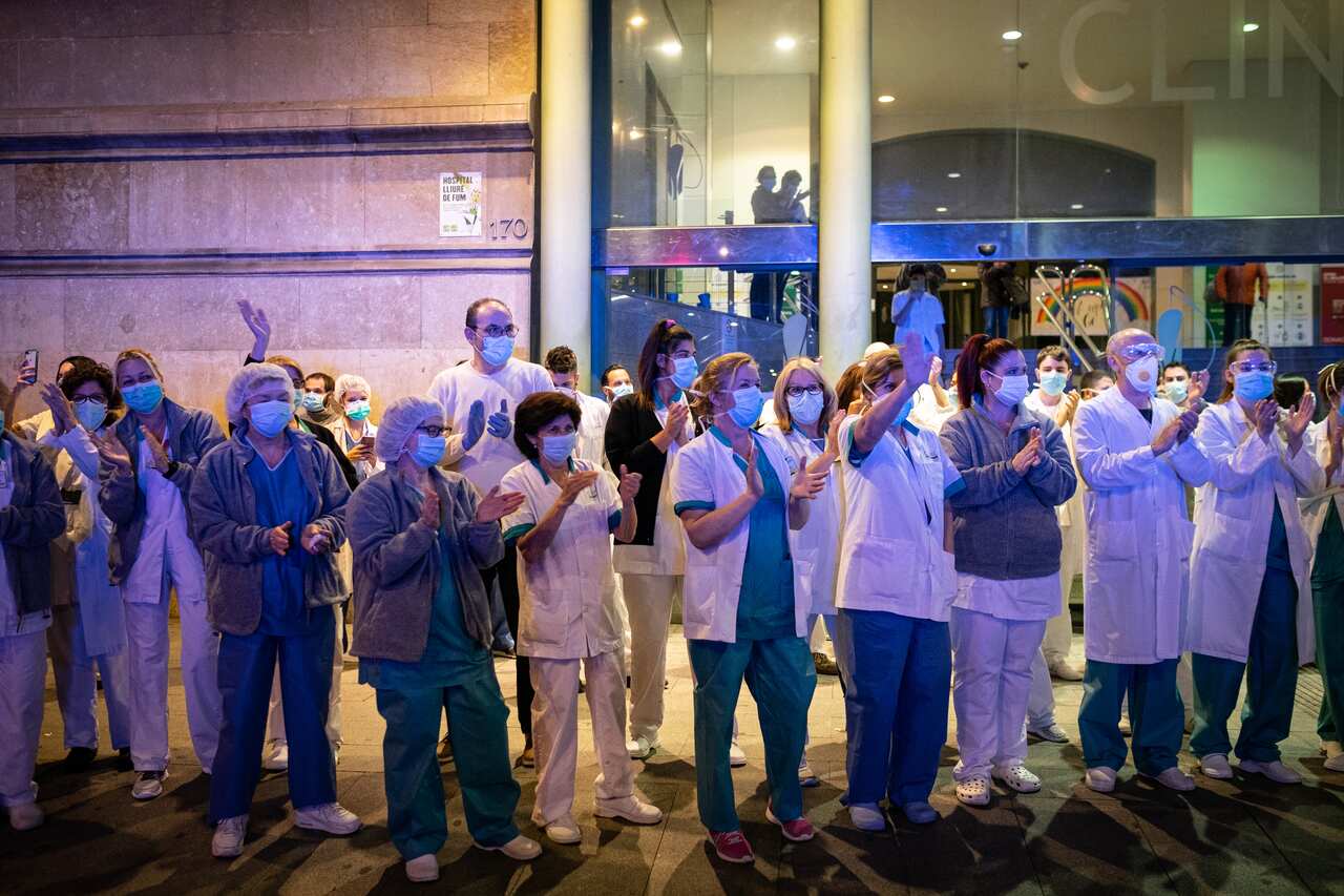 A group of doctors and health personnel at a Barcelona hospital applauding those that show gratitude towards them during the coronavirus crisis.