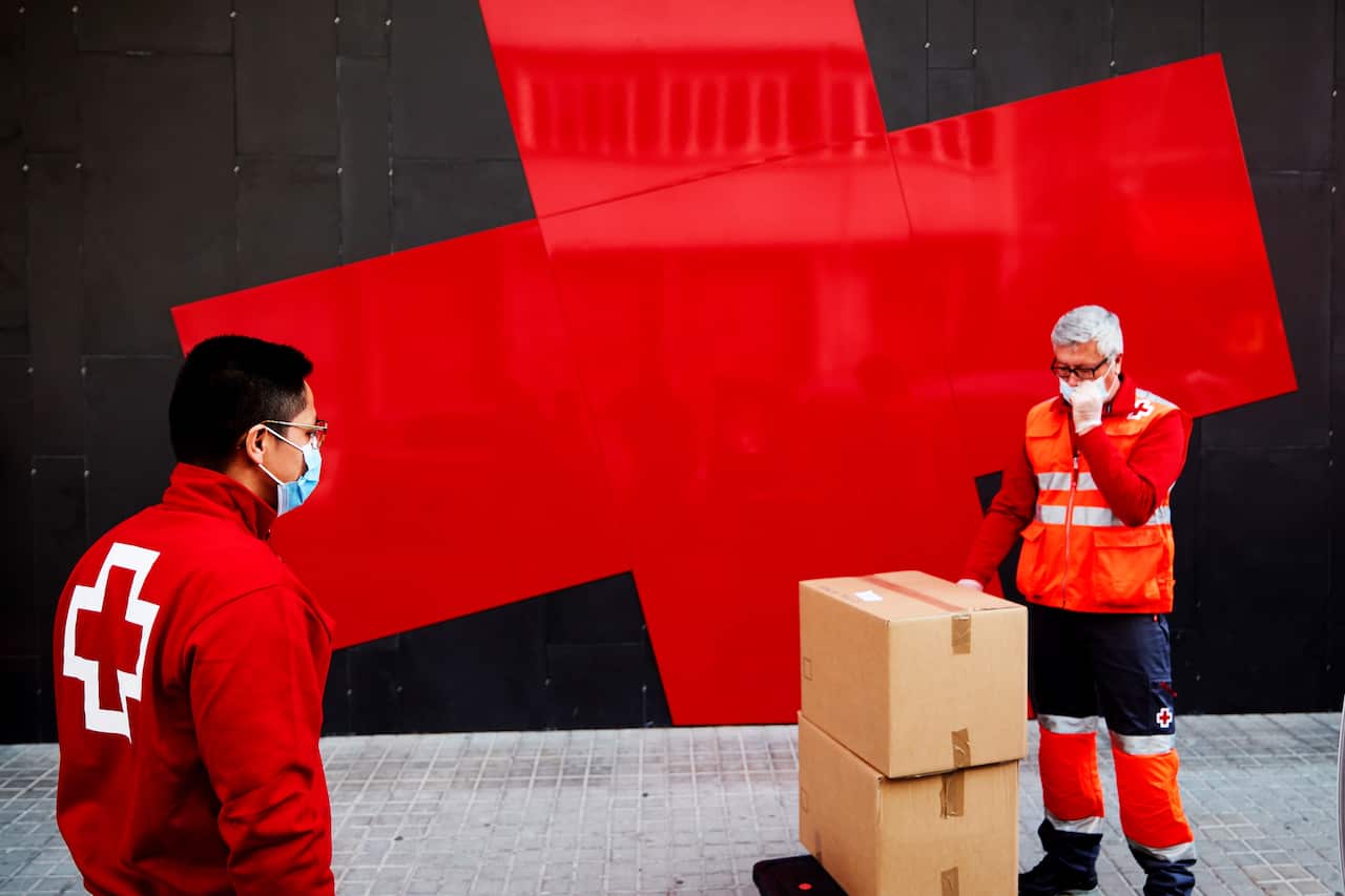 Spanish Red Cross volunteers deliver urgent aid and food for people in need in Barcelona, Catalonia.