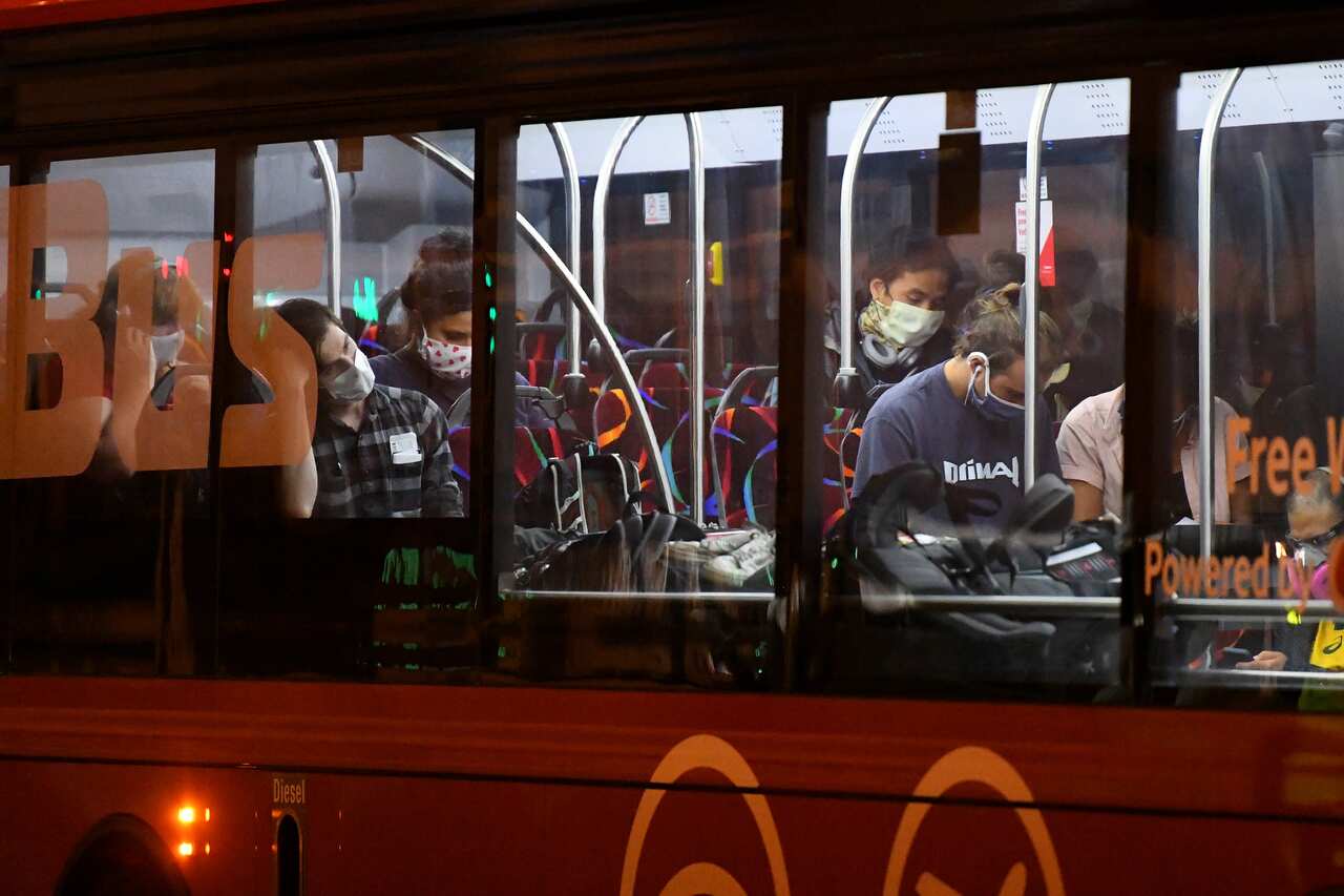 Australian travellers are carried on a bus at Sydney airport, in Melbourne.