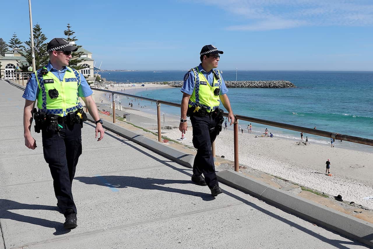 Police officers are seen patrolling Cottesloe Beach in Perth.
