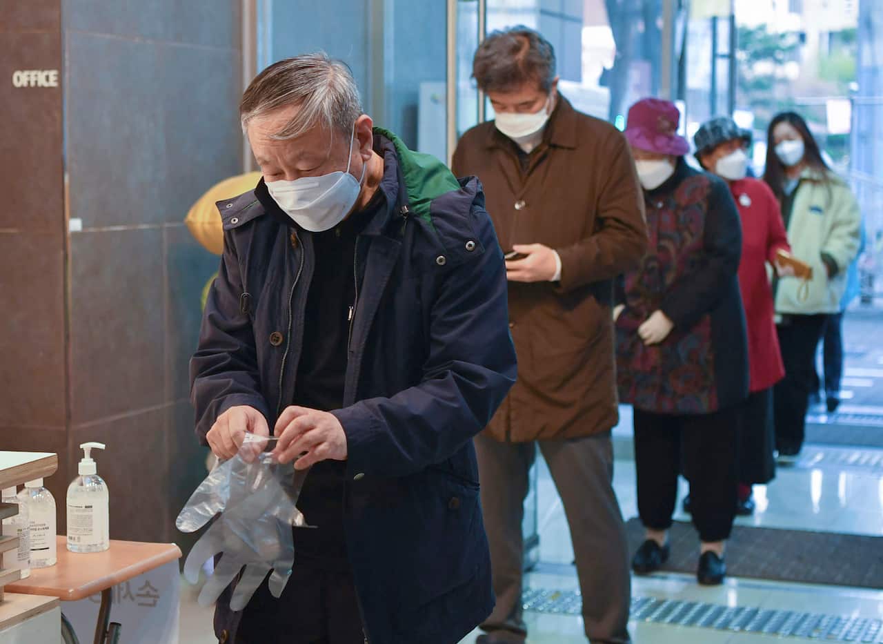 A queue forms at a polling station in Seoul, South Korea.