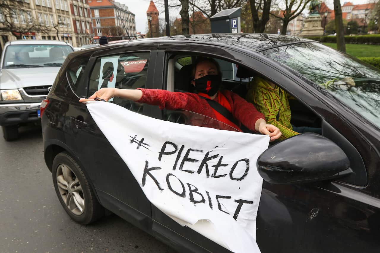 Protest participant inside the car with 'Women's hell'  banner is seen in Gdansk, Poland.