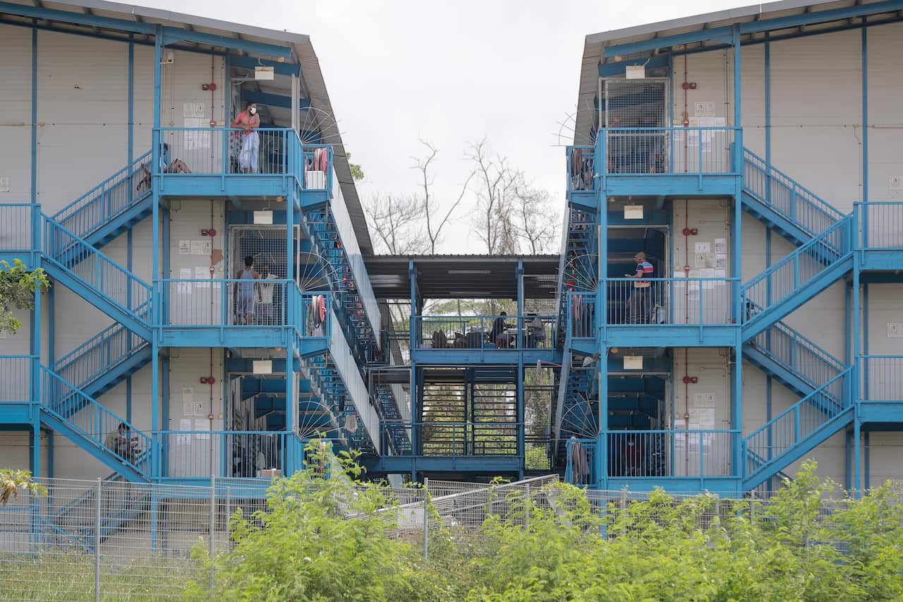 Labourers are seen along stairwells at the North Coast Lodge foreign worker dormitory.