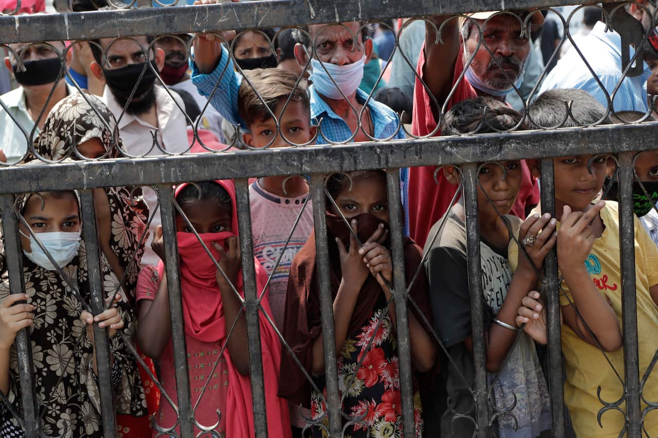 Indian children living in a slum wait for their food during the coronavirus lockdown.