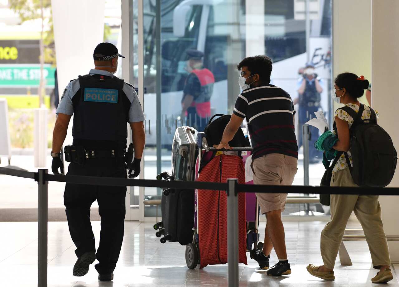 Travellers are seen boarding buses at Adelaide Airport in Adelaide, Monday, April 20, 2020.