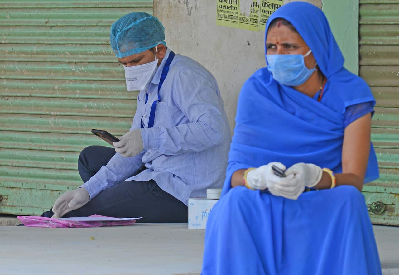 Medical staff wearing protective face mask at Roopnagar village , India.