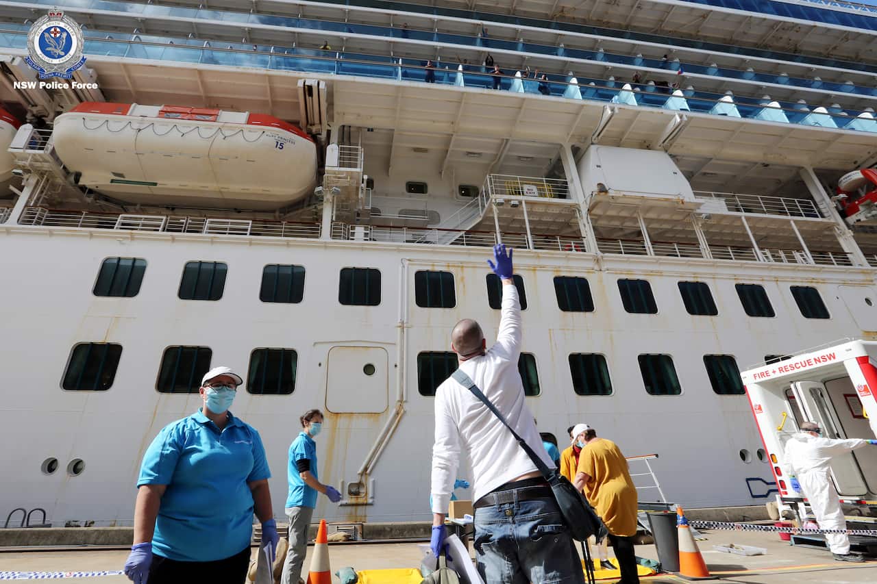 Crew members of the Ruby Princess cruise ship leaving the vessel at Port Kembla.
