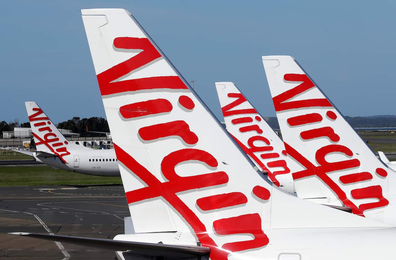 Virgin Australia planes are lined up at departure gates at Sydney Airport in Sydney.