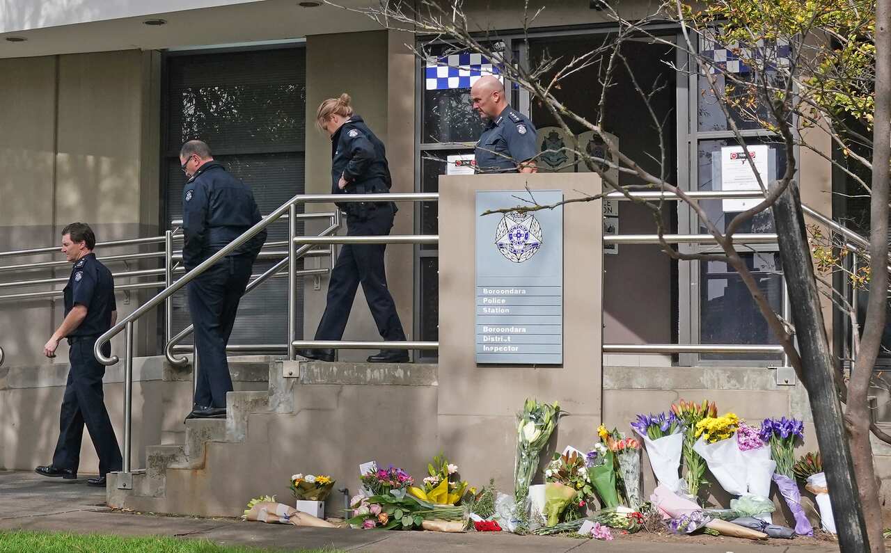 Tributes outside the Boroondara Police Station near the Chandler Highway in Kew.
