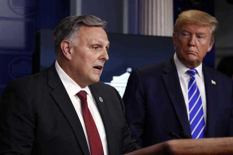 President Donald Trump (R) listens to Bill Bryan, head of science and technology at the Department of Homeland Security (R) 