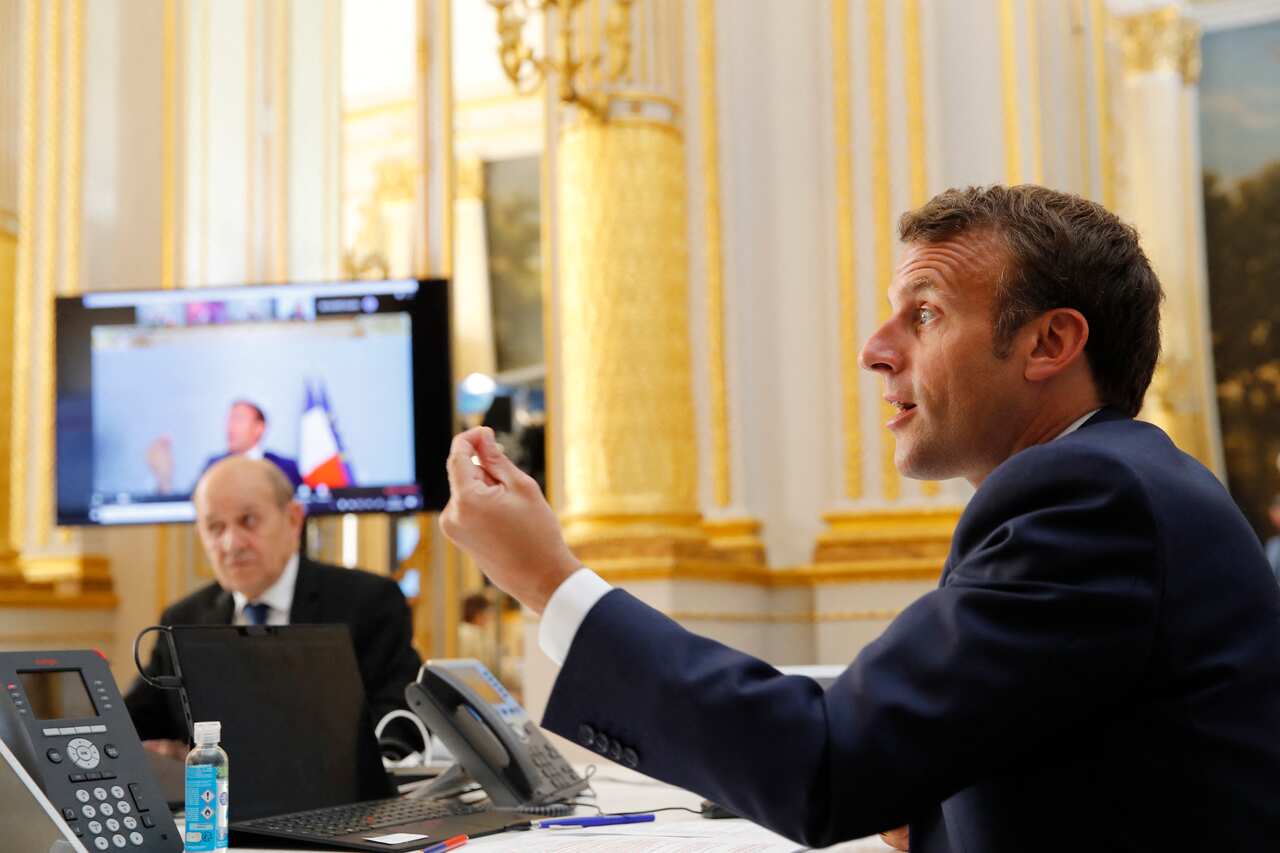 French President Emmanuel Macron speaks with WHO Director-General Tedros Adhanom Ghebreyesus during a video conference.