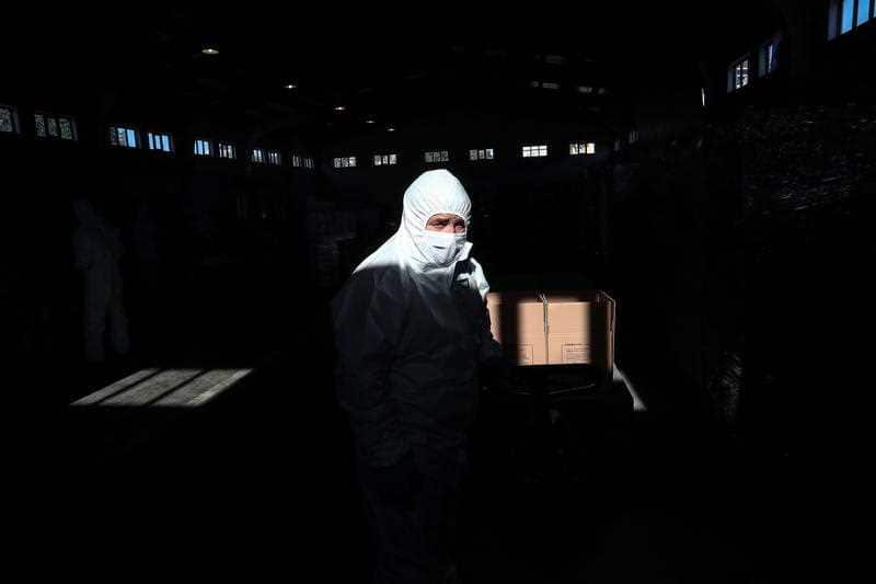 A man wearing a protective suit prepares Ramadan Food packages to be distributed to households in Istanbul, Turkey, 24 April