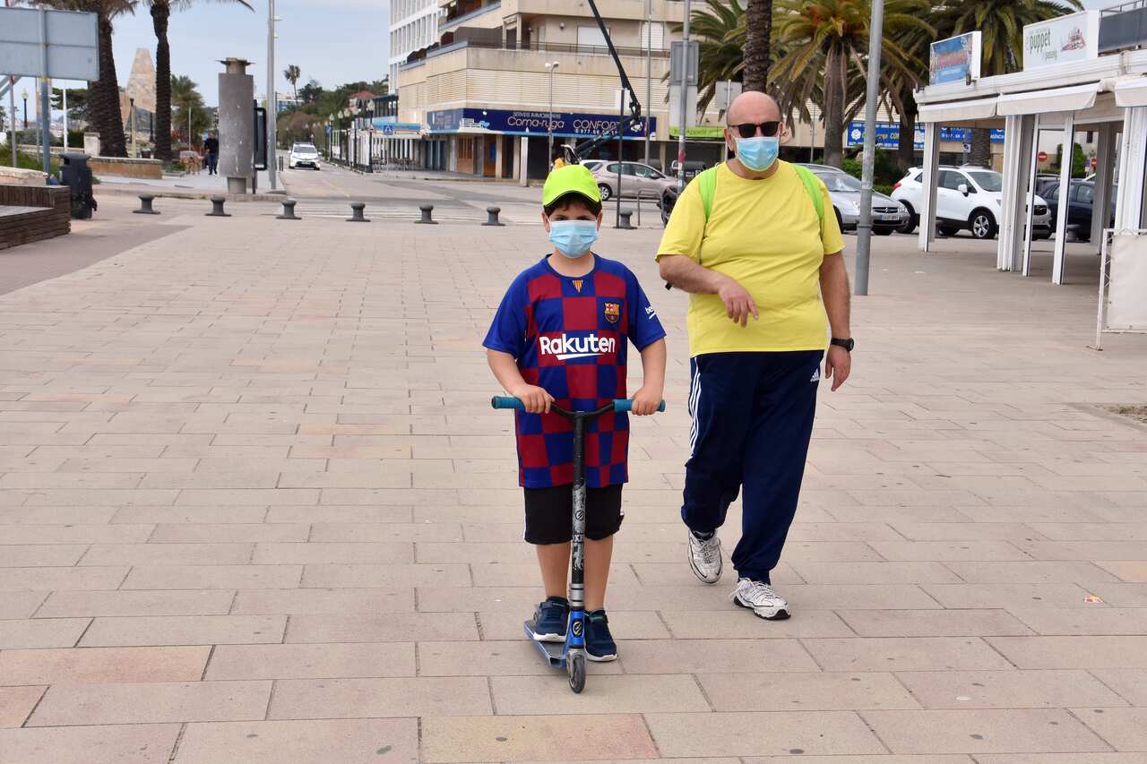 A father with his son during the first day of allowing children to go out in Spain.