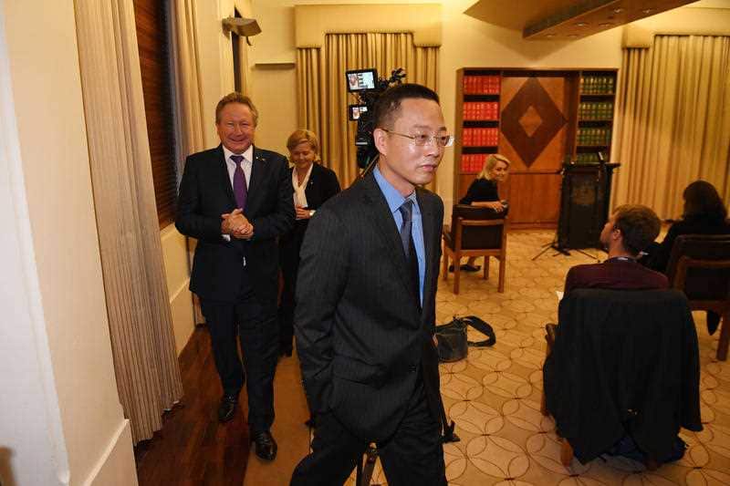Long Zhou (centre) departs a press conference at the Commonwealth Parliamentary Offices in Melbourne, Wednesday, April 29, 2020
