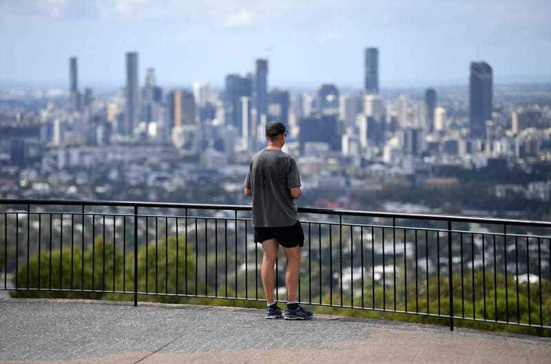 A visitor takes in the view from the Mt Coot-Tha lookout in Brisbane, Wednesday, April 29, 2020.