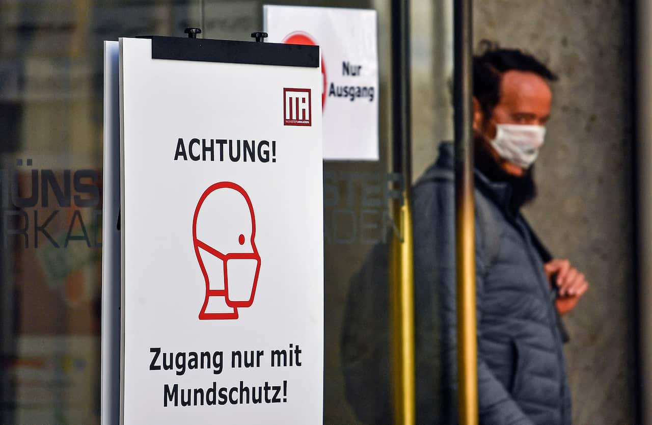 A sign at a shopping centre asks visitors to wear face masks in Muenster, western Germany.