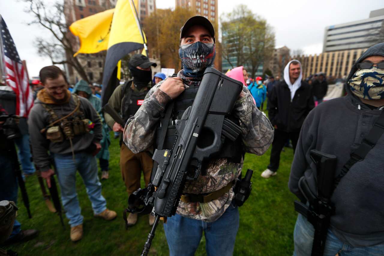 A protester carries his rifle at the State Capitol in Michigan.