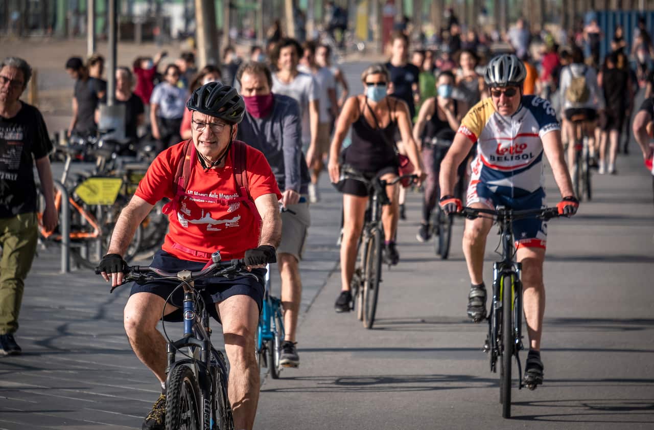 Cyclists ride along the streets of Barcelona as strict coronavirus lockdown measures partially lift, 2 May, 2020.