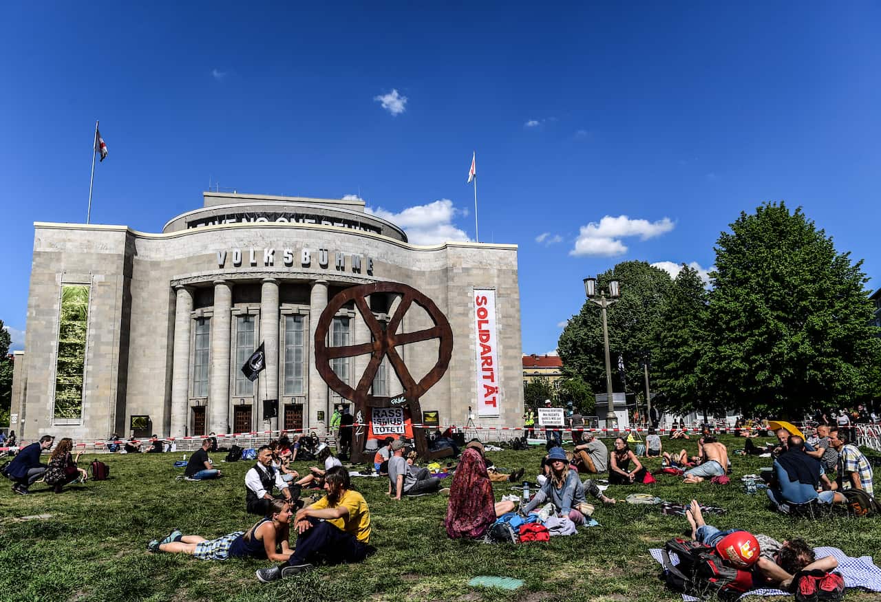 Demonstrators attend a so called 'Hygiene-Demo' at the Rosa Luxemburg Place in Berlin, Germany on 9 May.