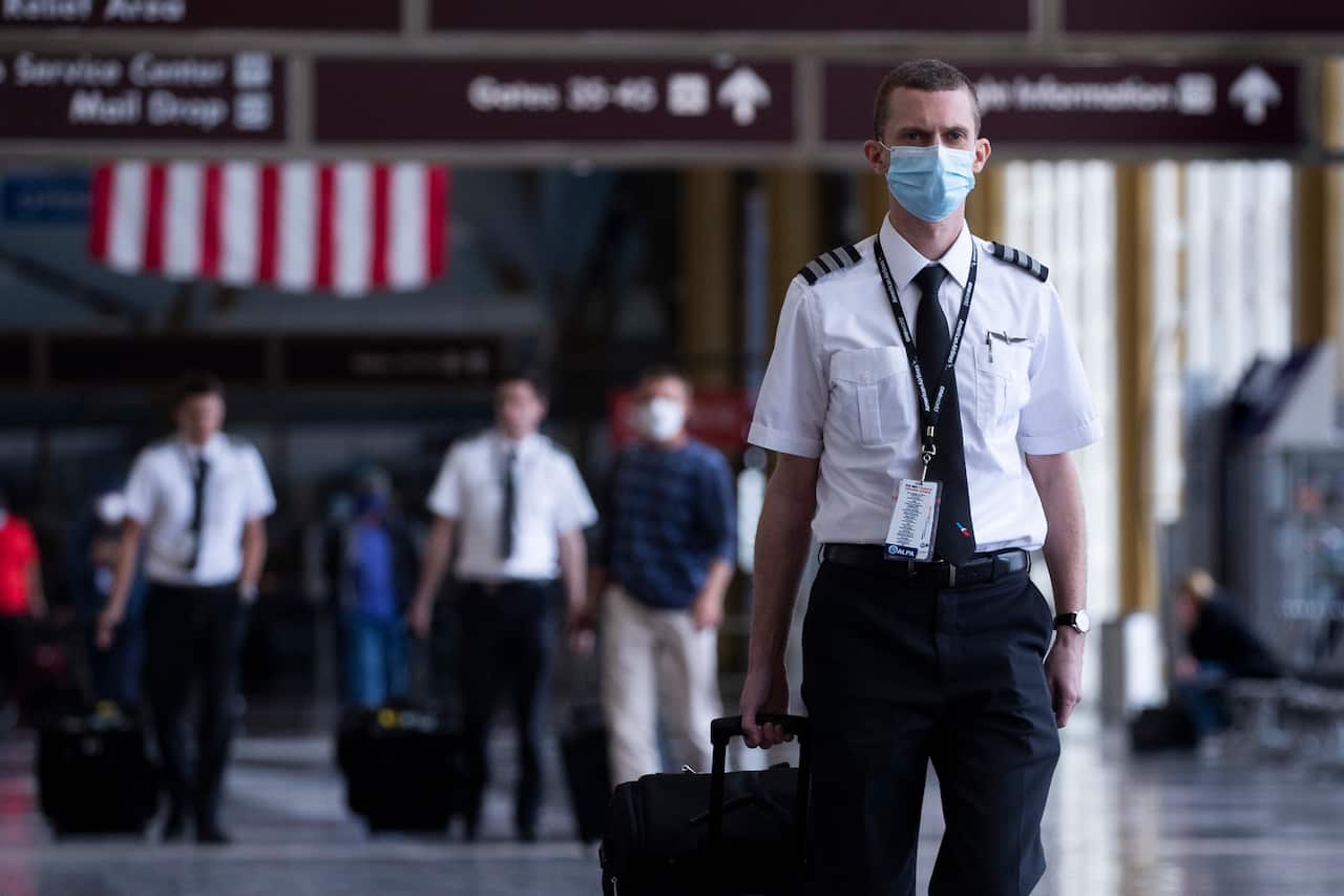 Pilots walking through a terminal at Ronald Reagan Washington National Airport in Arlington, Virginia, USA, 12 May 2020.