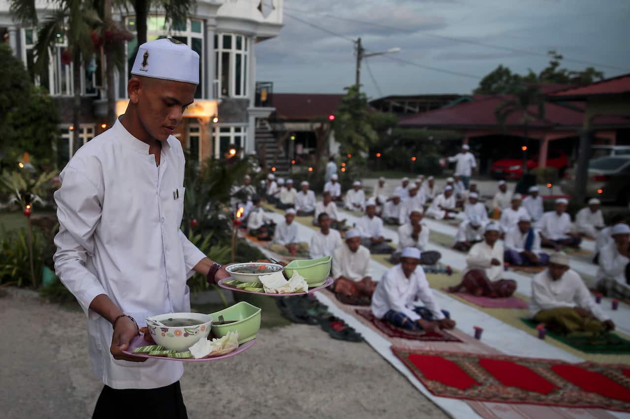 Worshippers break fast at a mosque near Kuala Lumpur.