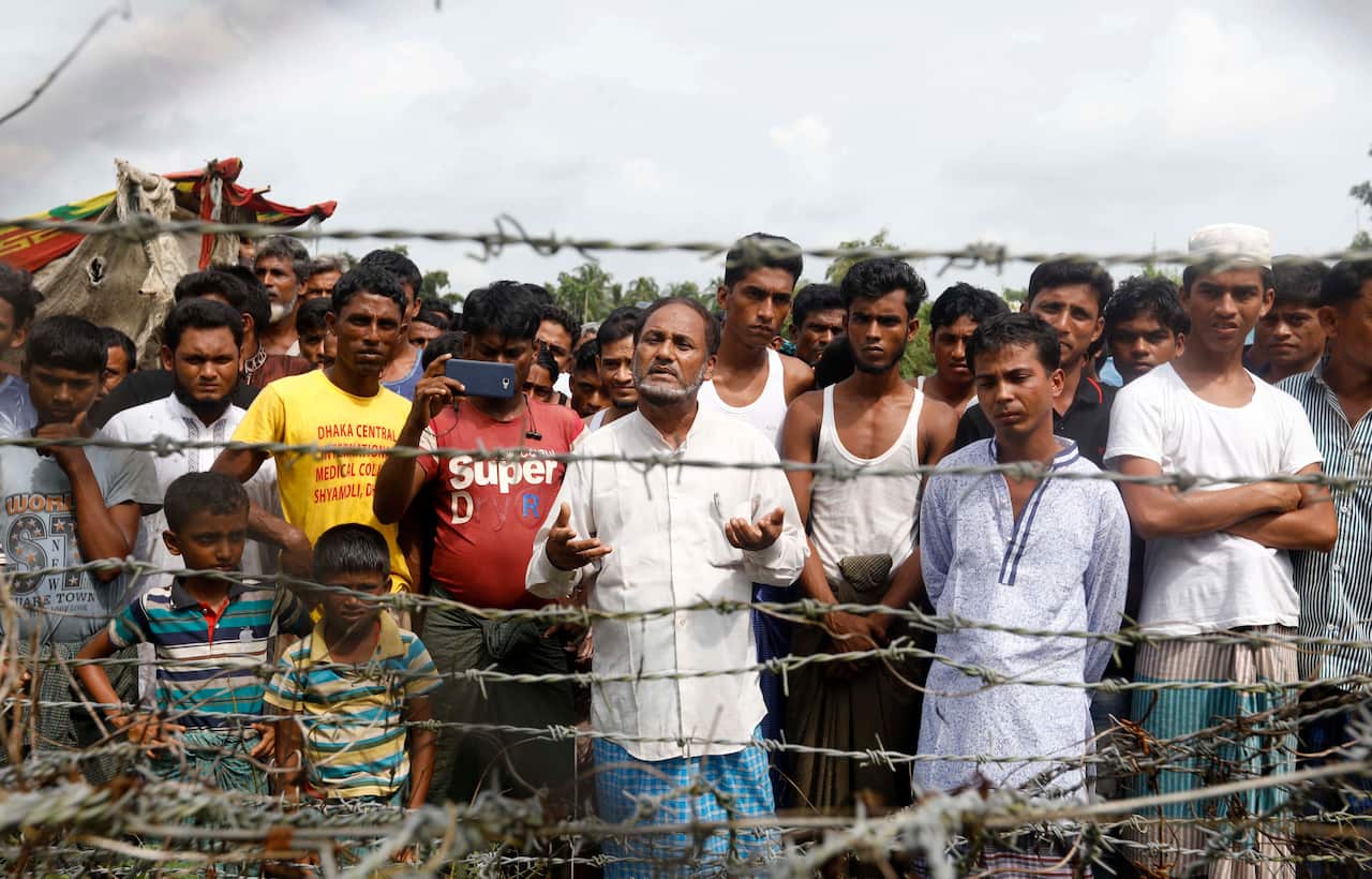 Rohingya refugees gather near the fence at the 'no man's land' zone between the Bangladesh-Myanmar border in Maungdaw district, Rakhine State.