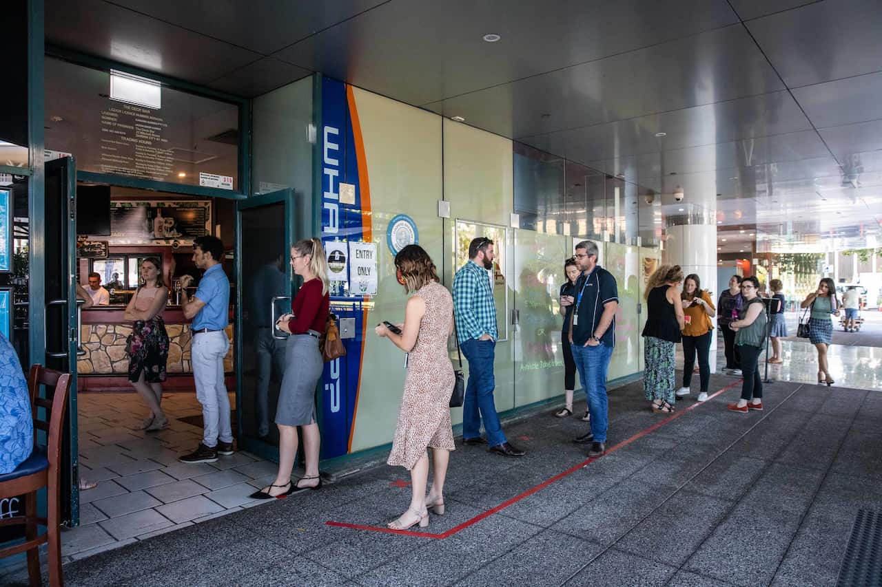 People wait in line at the Deck Bar in Darwin on 15 May 2020