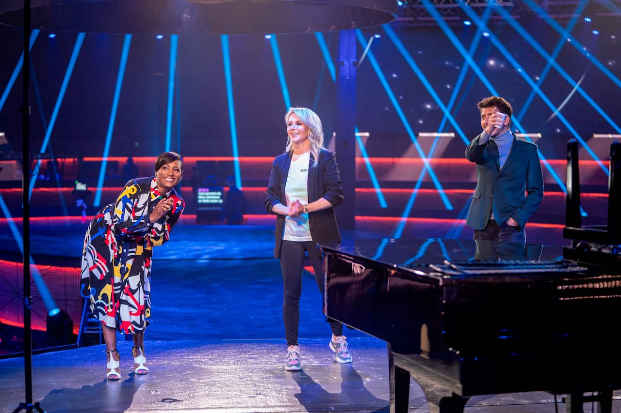 The three hosts Edsilia Rombley, Chantal Janzen, and Jan Smit, from left to right, joke during rehearsal for the Eurovision's Europe Shine A Light. 