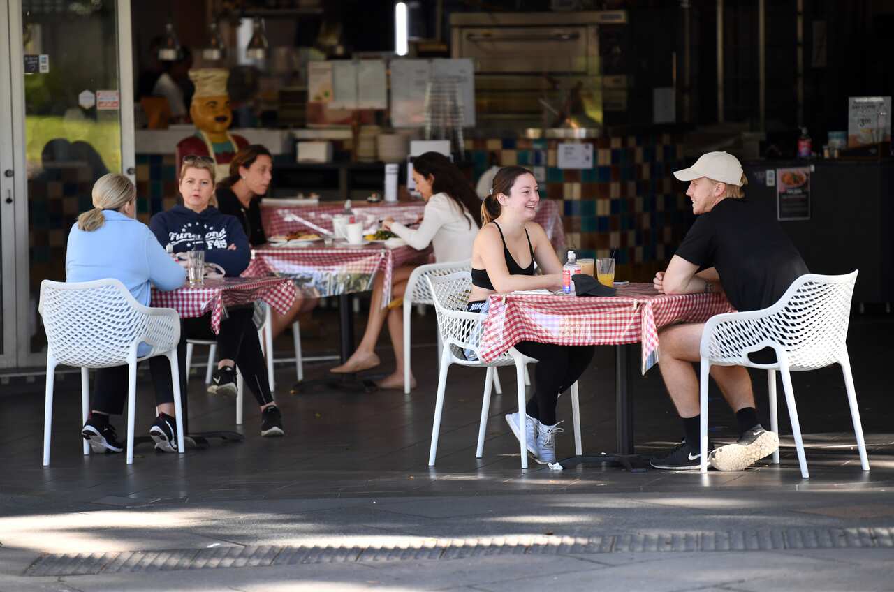 Cafe customers sit at tables distanced from each other in Southbank in Brisbane, Sunday, 17 May, 2020.  