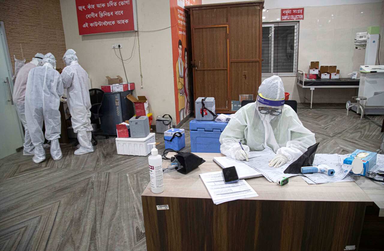 An Indian doctor collecting samples at Guwahati Medical College Hospital in Gauhati, India, Sunday, May 2020.