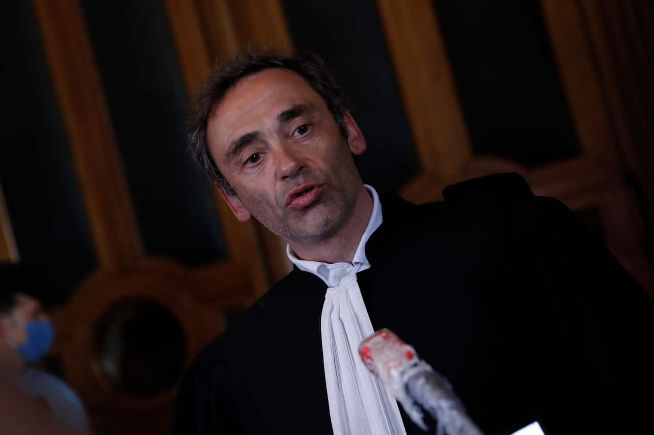 Laurent Bayon, one of Felicien Kabuga's French lawyers, speaks to reporters outside the courtroom.