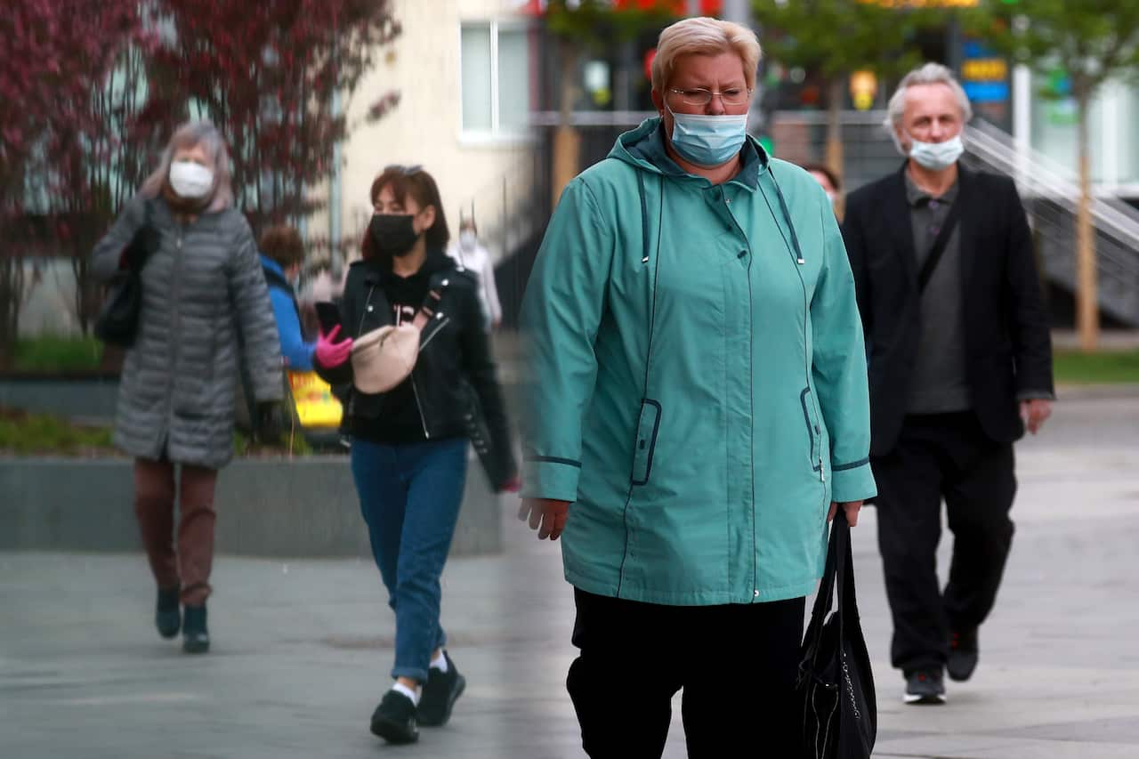 People walk in a street in Moscow.