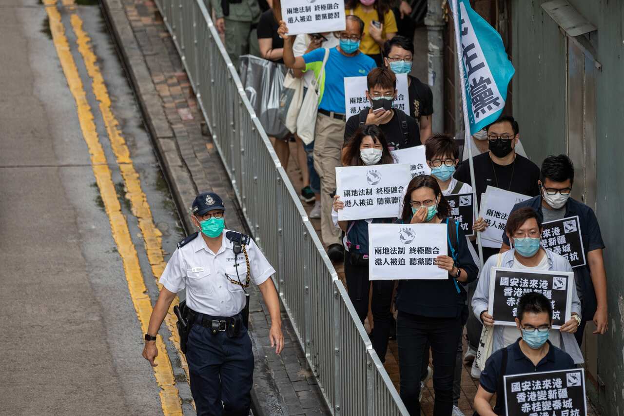 Pan-democrat lawmakers and activists make their way to Chinas Liaison Office during a rally against a security law in Hong Kong, China.