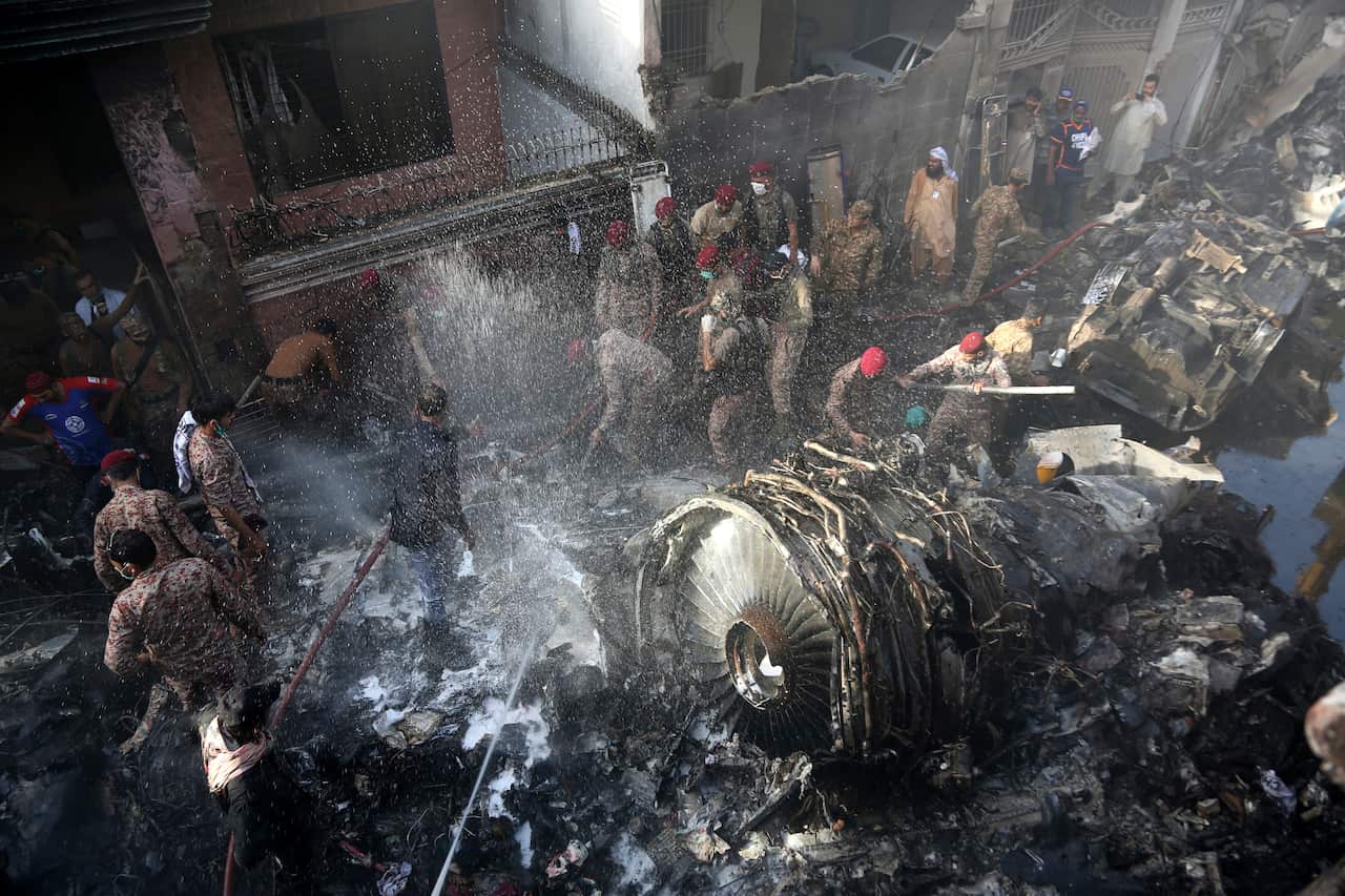 Volunteers look for survivors of a plane that crashed in residential area of Karachi, Pakistan.