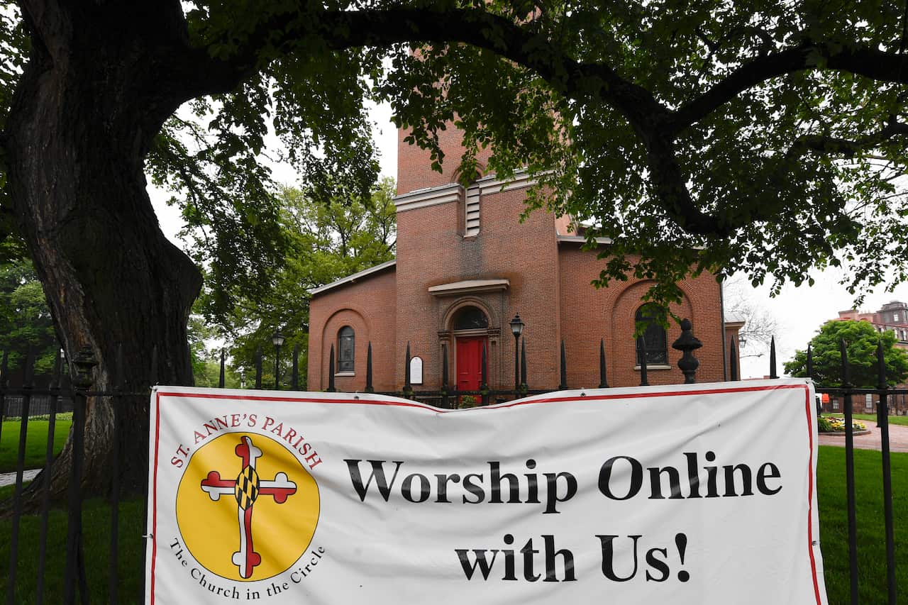 A sign hangs on the fence of St. Anne's Episcopal Church in Annapolis, Maryland.