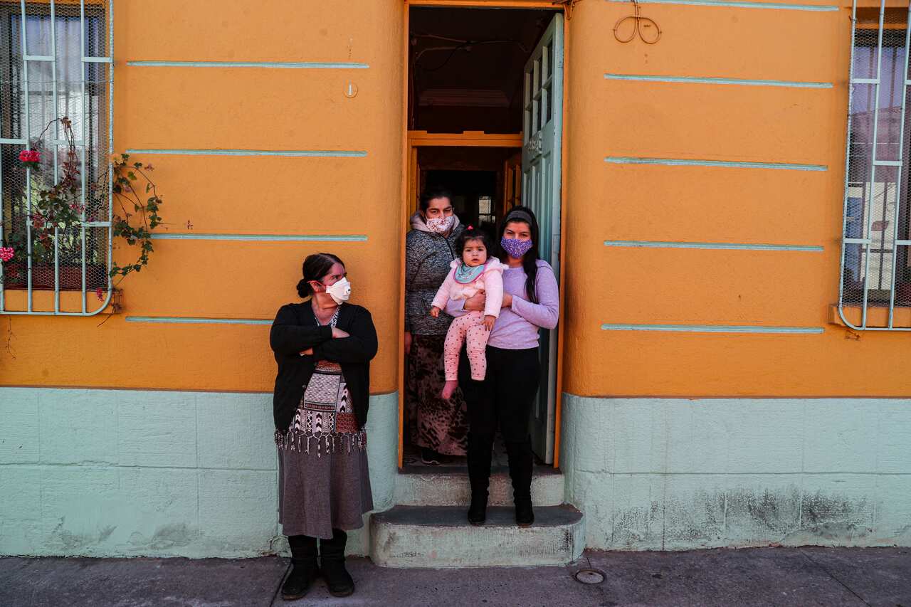 Residents watch as city workers deliver boxes of food, during a mandatory quarantine ordered by the government amid the coronavirus pandemic in Santiago, Chile.