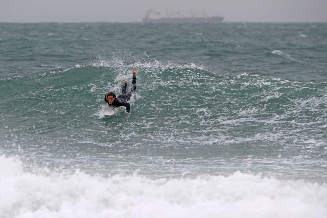 Surfers are seen at Port Beach in Fremantle.